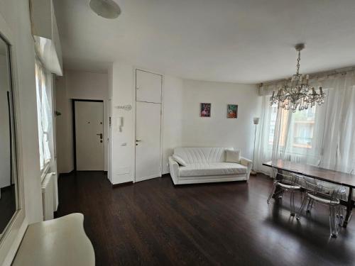 a living room with a white couch and a table at Sempione Red&Silver in Milan