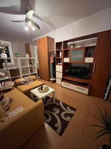 a living room with a couch and a tv at Dream's Tower BO in Bologna