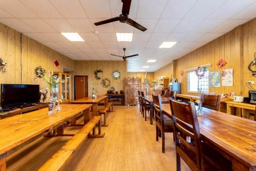 a dining room with wooden tables and chairs at Monica Workshop in Renai