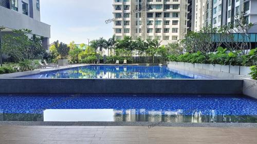 une grande piscine d'eau bleue dans une ville dans l'établissement D'Smart Living Homestay, Service Apartment, à Seri Kembangan