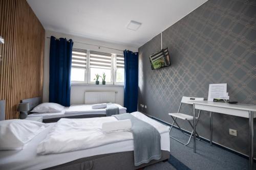 a hospital room with two beds and a desk at City Place Noclegi in Wrocław