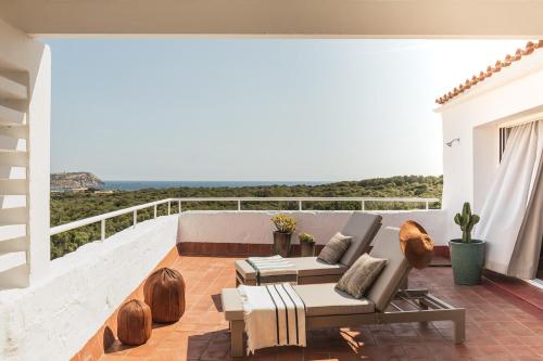 a patio with a view of the ocean from a house at Binissaida Boutique Hotel in Es Castell