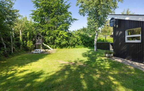 a yard with a house and a playground at Stunning Home In Sæby With Wifi in Sæby