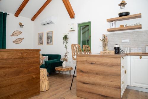 a kitchen and living room with a green couch at Casa Olive in Šibenik