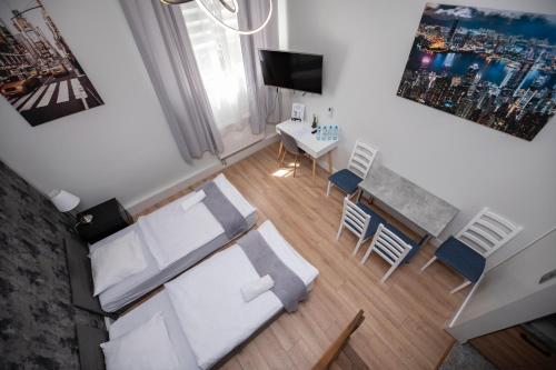 a living room with a white couch and a table at City Place Noclegi in Wrocław