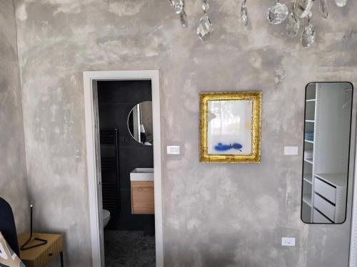 a bathroom with a mirror and a picture on the wall at Mari's double bedroom in Umag
