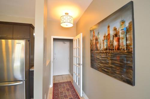 a hallway with a large painting on the wall at The SoMa Furnished Residences in Hamilton