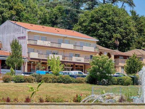 a building with cars parked in a parking lot at Studio rénové 2 pers à Barbotan, proche du Lac de l'Uby ! - FR-1-841-18 in Barbotan-les-Thermes
