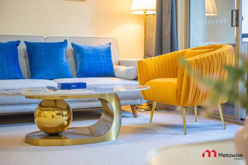 a living room with a couch and a table and a chair at MetaWise Cozy 1BR City Pad W Parking Near RPA & Sydney Uni in Sydney