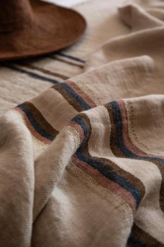 a close up of a striped blanket on a bed at Binissaida Boutique Hotel in Es Castell