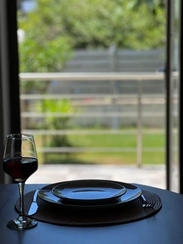a table with a plate and a glass of wine at Irene' s Place in Olympia