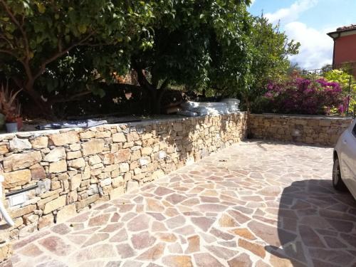 a stone retaining wall and a stone patio at Vlletta da Amare in Imperia