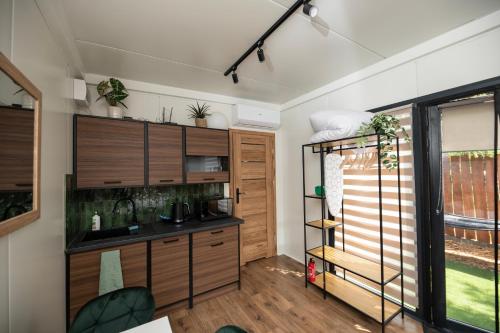 a room with a kitchen with wooden cabinets at City Place Noclegi in Wrocław