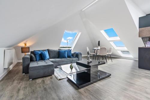 a living room with a couch and a table at Stunning Penthouse-Style 2-Bed Uxbridge in Uxbridge
