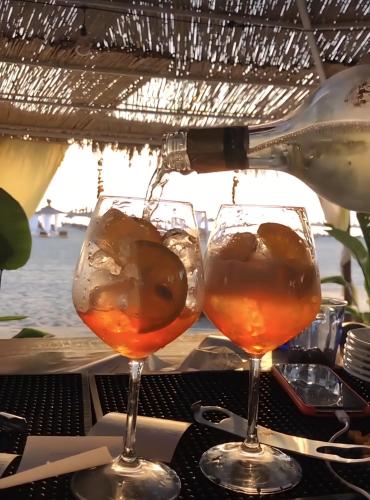 two wine glasses sitting on top of a table at Premium Melia Garden Apartment in Lalzit Bay