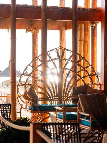 a patio with a table and chairs and a window at Premium Melia Garden Apartment in Lalzit Bay