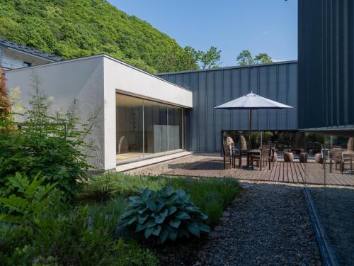 an external view of a house with an umbrella at 小樽旅亭 蔵群 in Otaru
