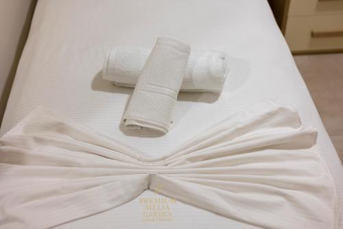 a bed with two rolls of toilet paper on it at Premium Melia Garden Apartment in Lalzit Bay