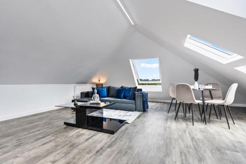 a living room with a couch and a table at Stunning Penthouse-Style 2-Bed Uxbridge in Uxbridge