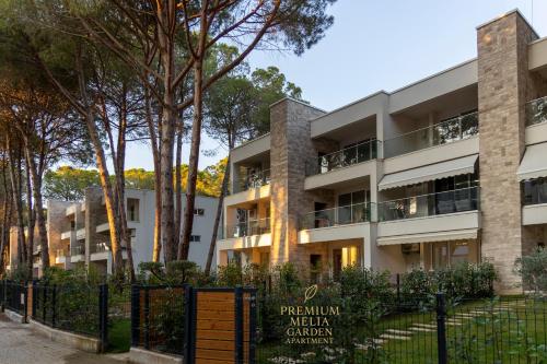 an apartment building with a sign in front of it at Premium Melia Garden Apartment in Lalzit Bay