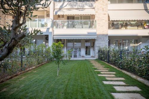 a garden in front of a building at Premium Melia Garden Apartment in Lalzit Bay