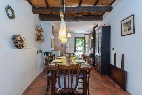 a dining room with a wooden table and chairs at Dimora Concept - Casa Laetitia in Pornassio