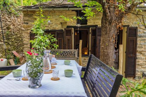 a table with a blue table cloth and flowers on it at Dimora Concept - Casa Laetitia in Pornassio