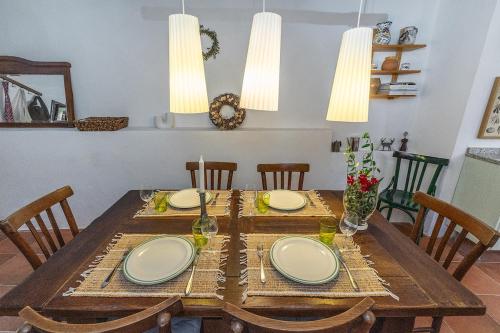 a wooden table with plates on top of it at Dimora Concept - Casa Laetitia in Pornassio