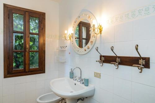 a bathroom with a sink and a mirror at Dimora Concept - Casa Laetitia in Pornassio
