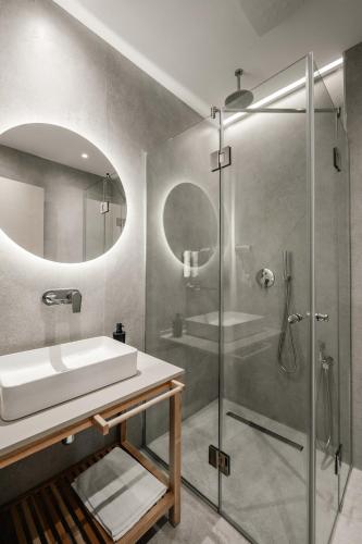 a bathroom with a sink and a shower at Sharm Hotel Luxury in Gjirokastër