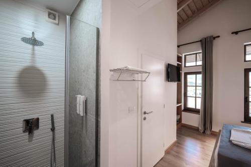 a bathroom with a shower and a glass door at Sharm Hotel Luxury in Gjirokastër