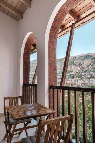 a table and chairs on a balcony with a view at Sharm Hotel Luxury in Gjirokastër