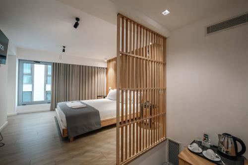 a hotel room with a bed and a large partitioned room at Sharm Hotel Luxury in Gjirokastër