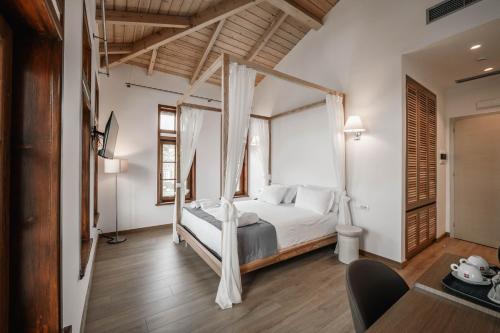 a bedroom with a bed with a mosquito net at Sharm Hotel Luxury in Gjirokastër