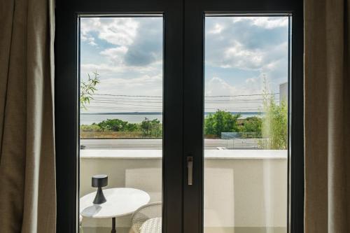 a room with a window with a view of a balcony at Euforia Retreat and Spa in Eforie Nord