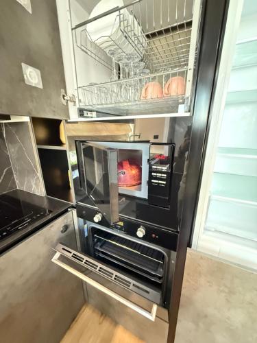 a kitchen with an oven with a tv in it at Nice Apartment in the Center, with Balcony in Crăsnăşeni