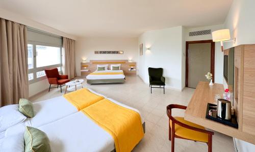 a hotel room with a bed and a living room at Sol Azur in Hammamet