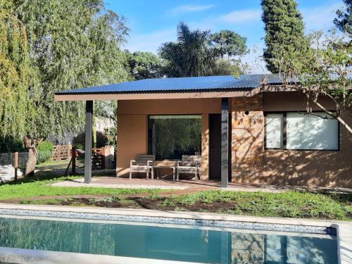 a house with a pool in front of it at Casa Lavanda in Sierra de los Padres
