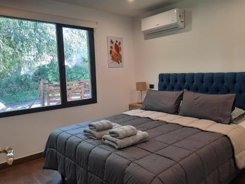a bedroom with a large bed with towels on it at Casa Lavanda in Sierra de los Padres