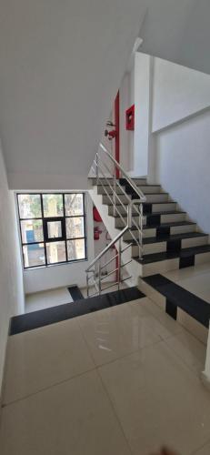 a spiral staircase in a building with two windows at Hotel Maharaja Inn in Pune