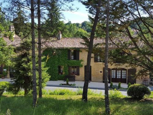 une maison avec du lierre poussant sur le côté dans l'établissement Auberge Lou Peyrol, à Montferrand-du-Périgord