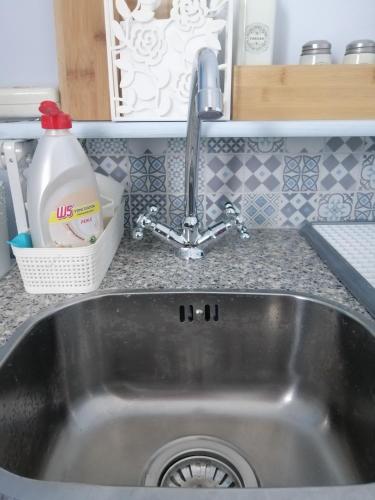 a kitchen sink with a faucet in a kitchen at Bluefullstop-Μπλε Τελεία in Artemida