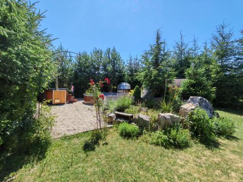 a garden with rocks and a gazebo at Nosce Te Ipsum in Sokolníky
