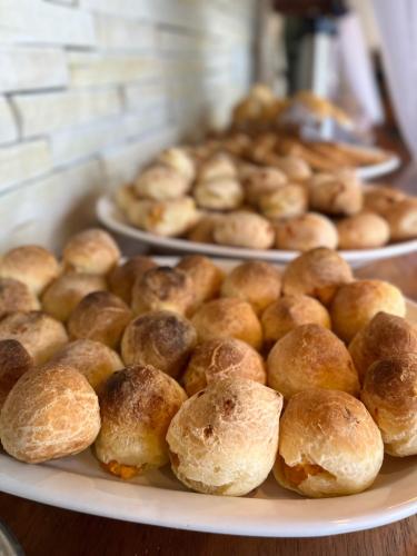 a plate of bread rolls on a table at Pousada Capitólio in Capitólio