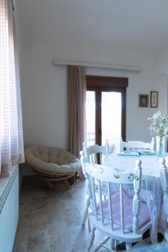 a dining room with a table and chairs and a couch at Stella's Home in Čitluk