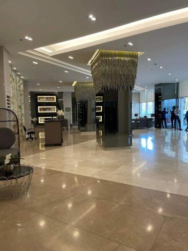 a lobby of a building with people walking in it at Fame Residences Tower 2 in Manila