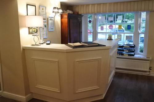 a large white island in a room with a window at Magpies Restaurant with Rooms in Horncastle