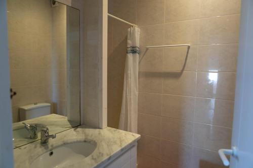a bathroom with a sink and a shower with a mirror at Apartment 1st sea line in Sa Tuna, Begur H85 in Isla Negra
