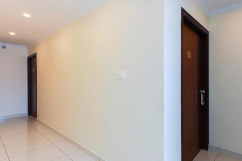 an empty room with a door and a corridor at Super Collection O Companion Leisure Homes in Kovalam