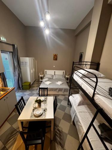 a room with two bunk beds and a table at PREVEZA DOWNTOWN garden in Preveza